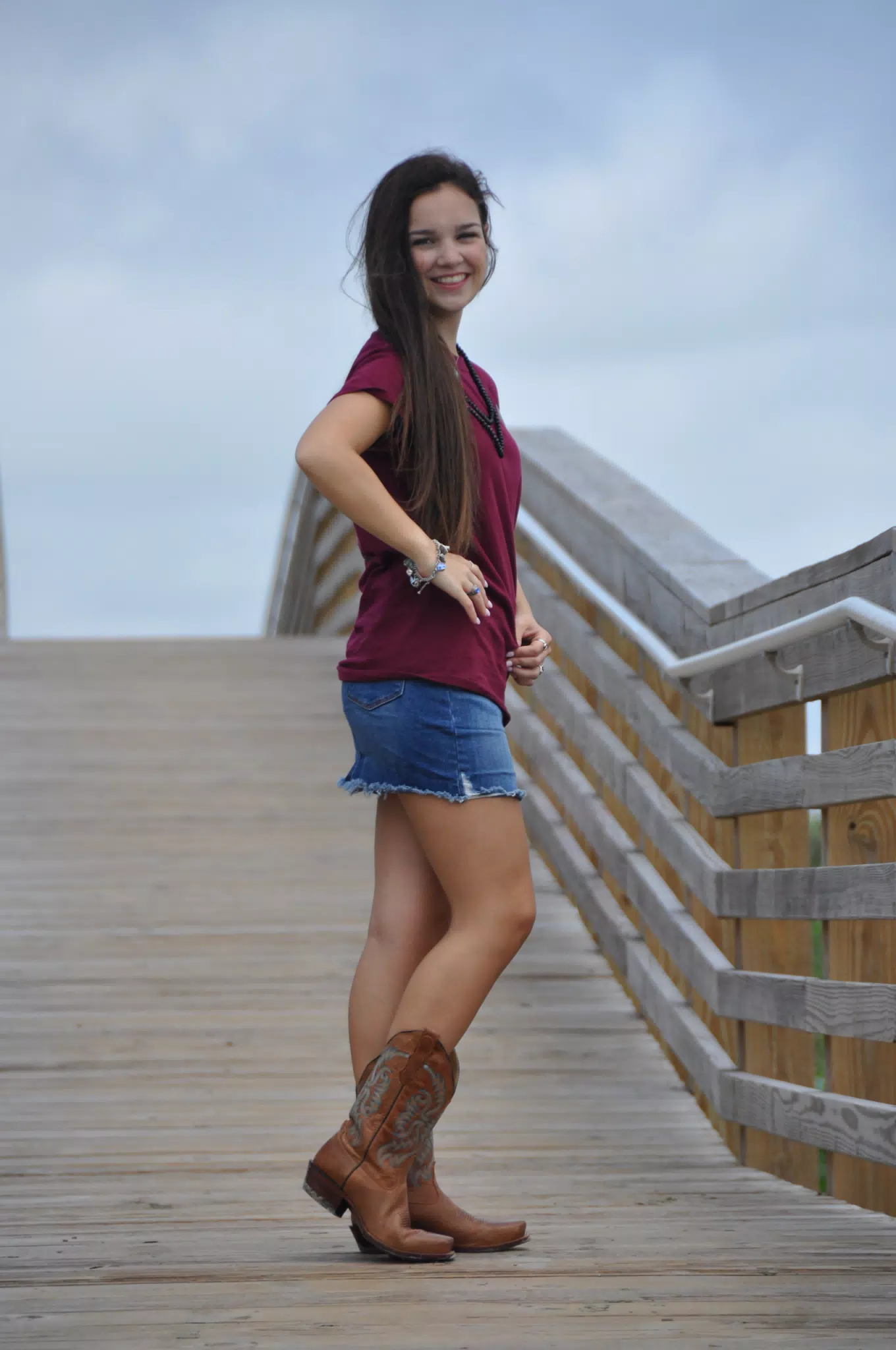 Emily on Galveston Boardwalk in Boots and Denim Skirt
