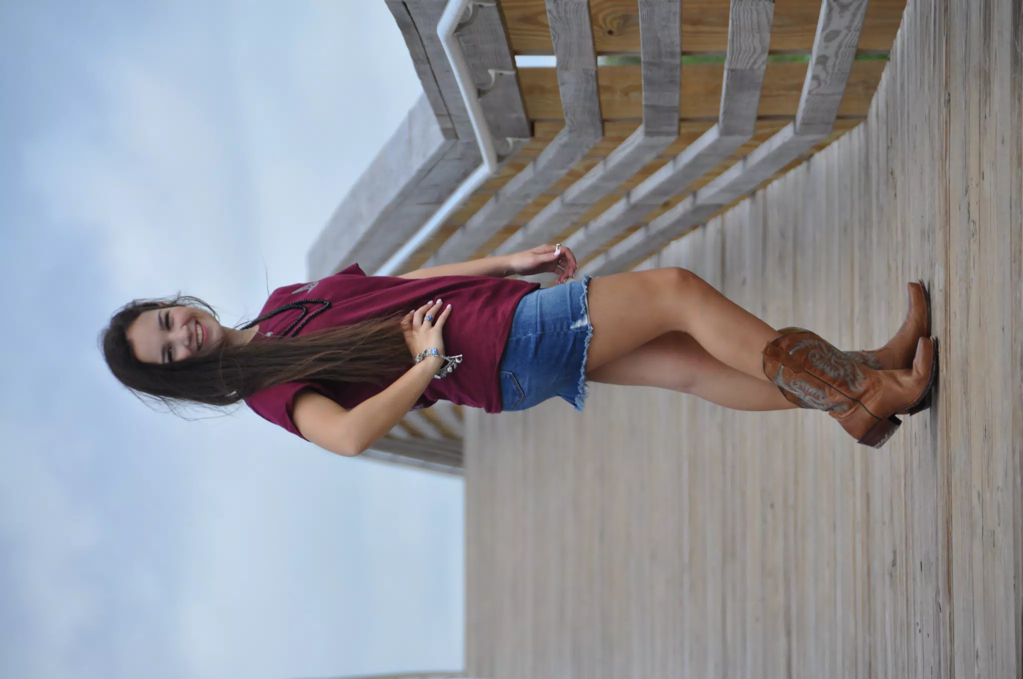Emily in Jean Miniskirt and Cowboy Boots on Galveston Wood Bridge Model