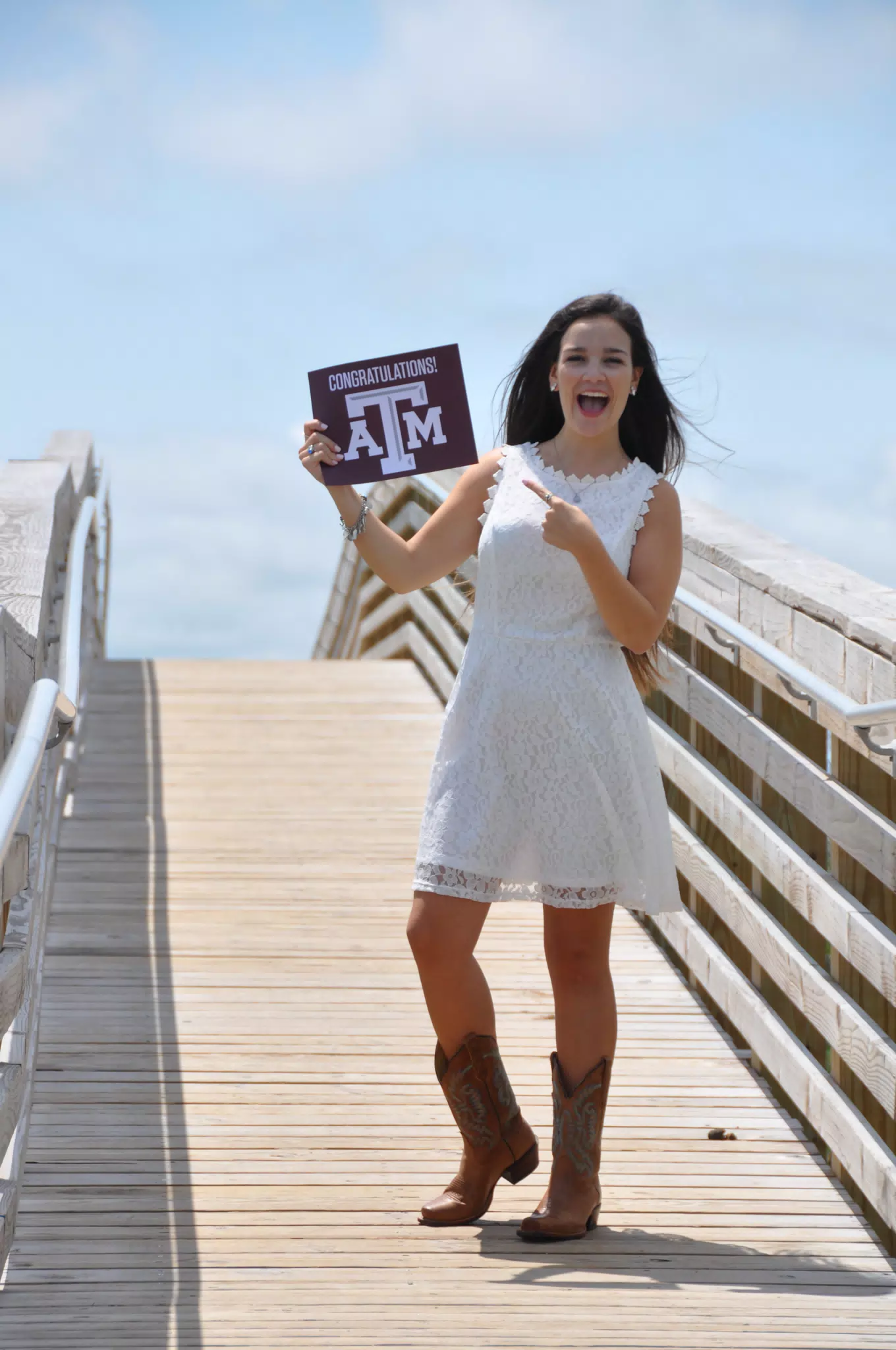 Excited Teen with Texas A&M Aggies Sign on Galveston Boardwalk