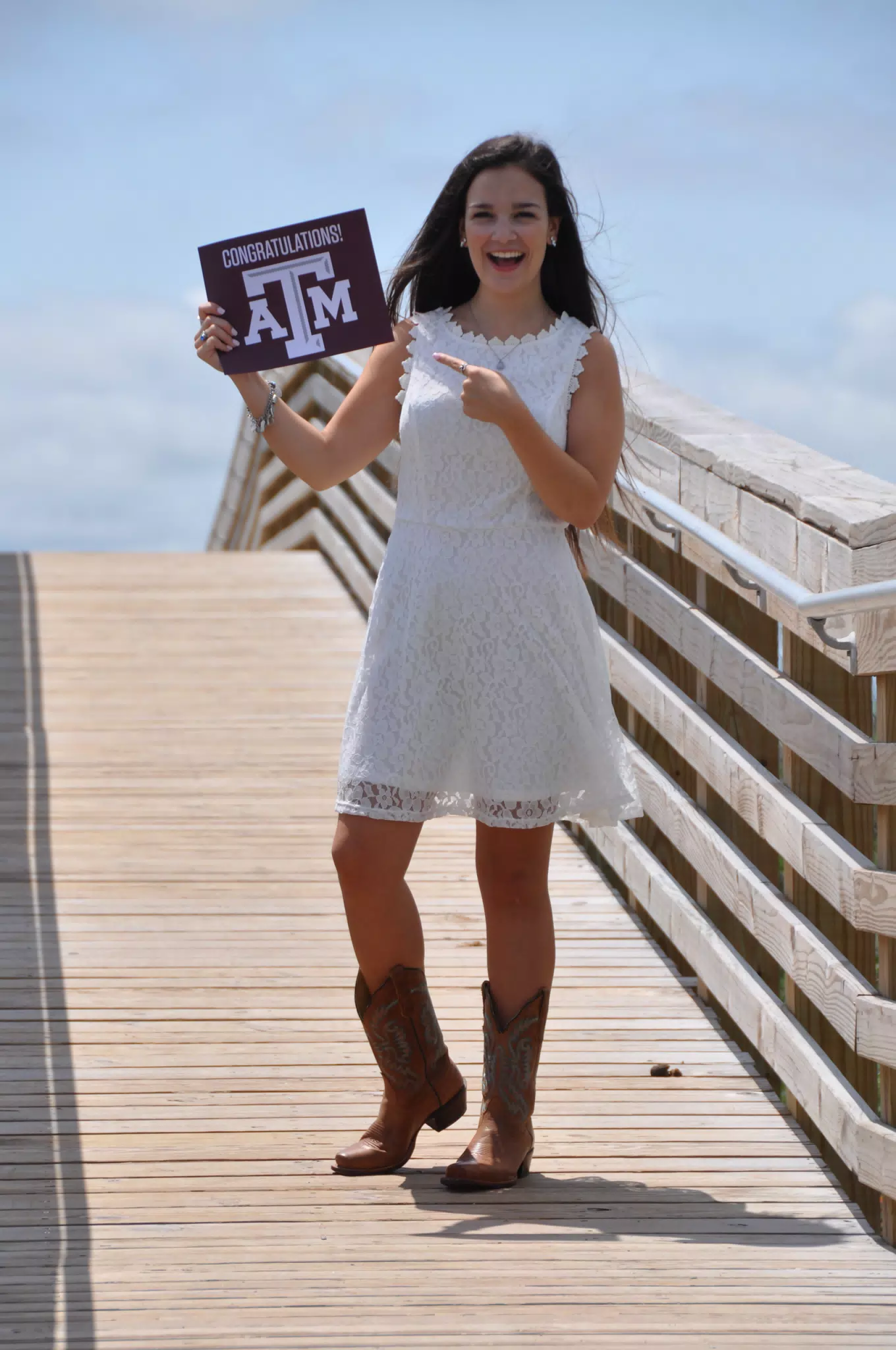 Teen Girl Pointing to Aggies Sign