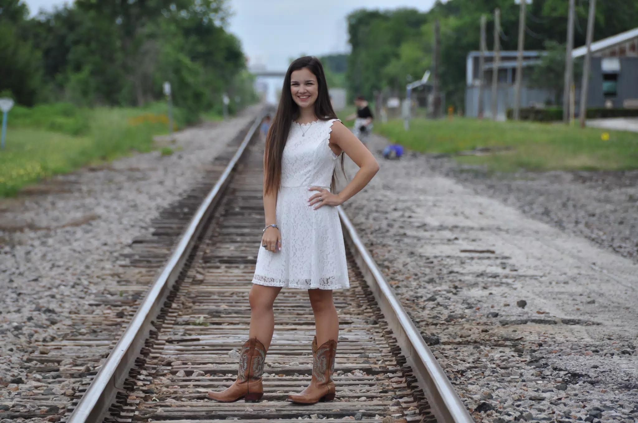 Emily in White Dress on Railroad Tracks