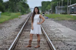 Emily in White Dress on Railroad Tracks