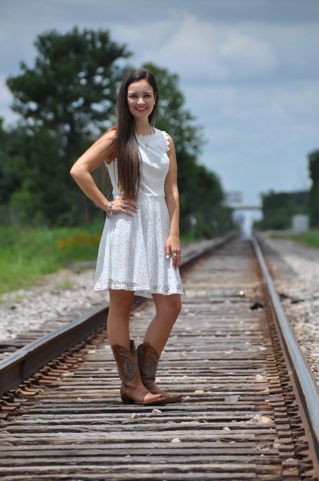 Teen Brunette Emily Modeling White Dress and Cowgirl Boots on Railroad Tracks in Galveston, Texas