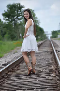 Teen Model in White Dress on Railroad Tracks