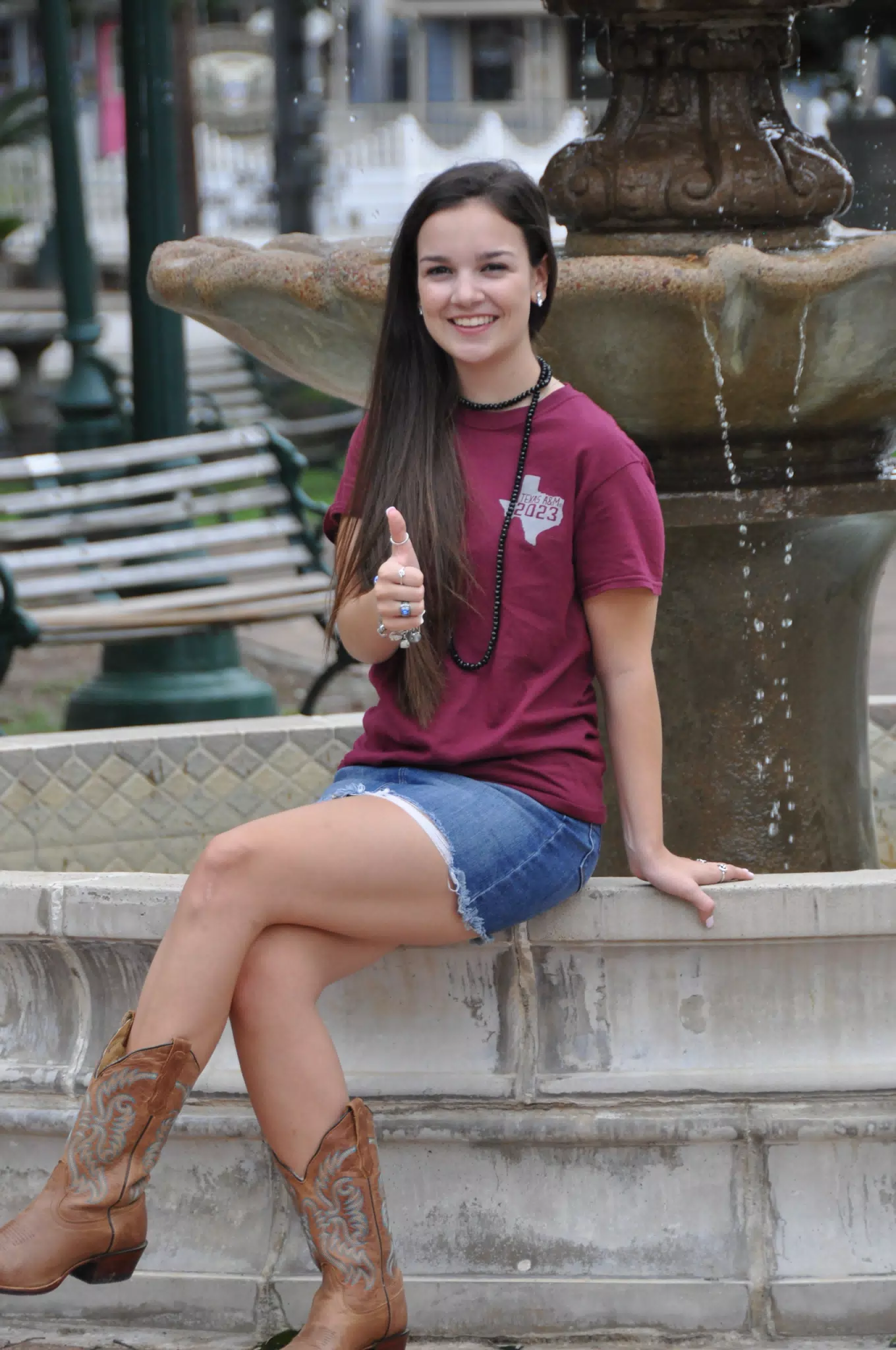 Emily Thumbs Up on Fountain in Skirt and Boots