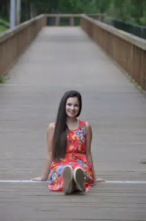 Long Haired Brunette Model in Red Dress on Boardwalk