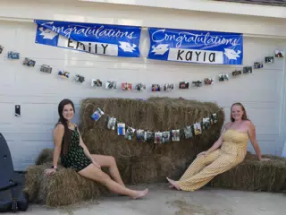 Emily and Kayla Reclining on Hay Bails in Texas
