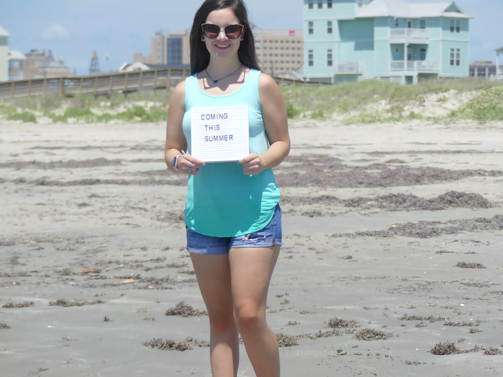 Emily with Coming This Summer Sign