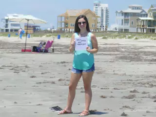 Emily on Galveston Beach with TakeFlight Sign