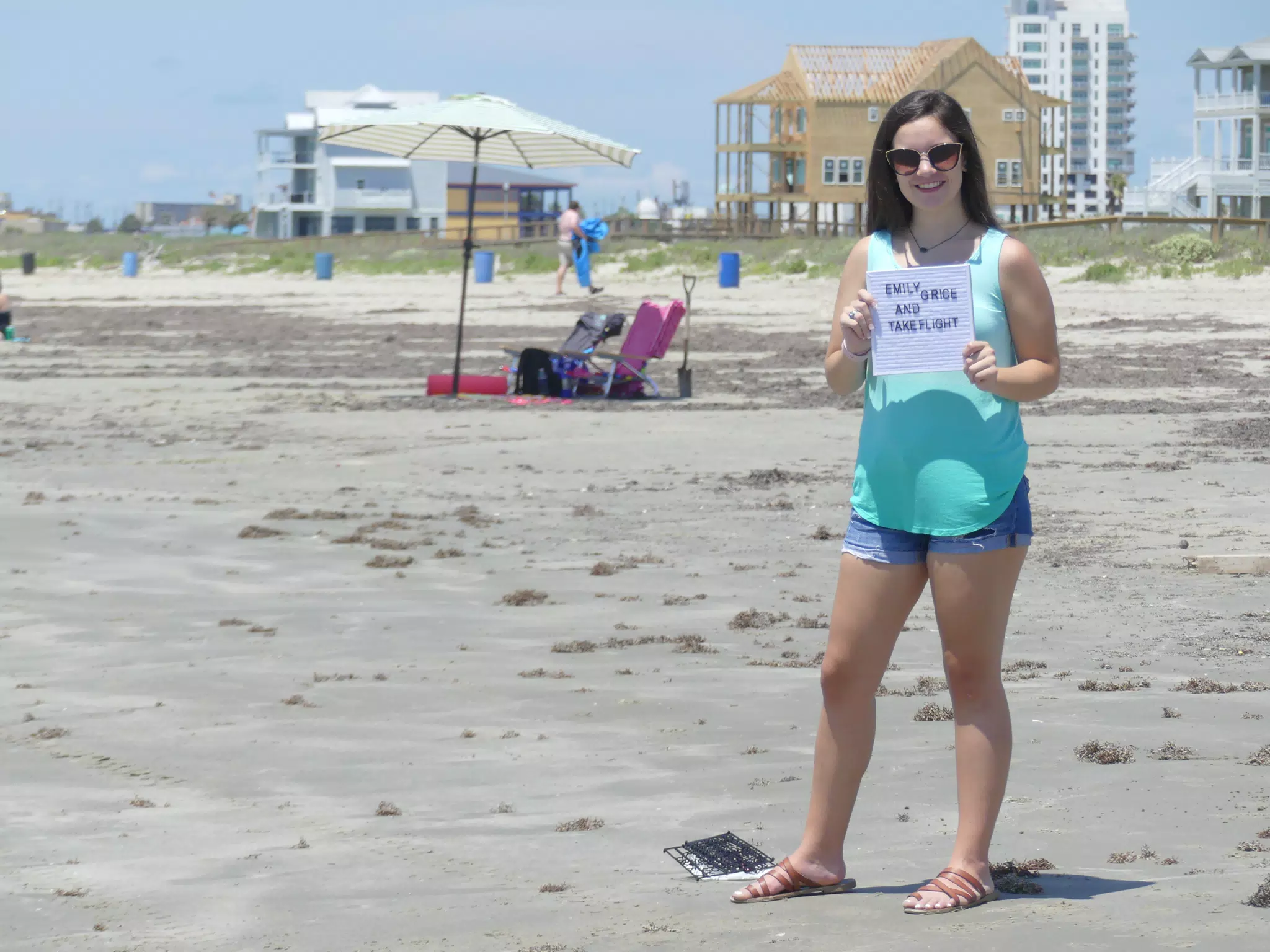 Emily in Sandals and Jean Shorts on Galveston Beach with Sign