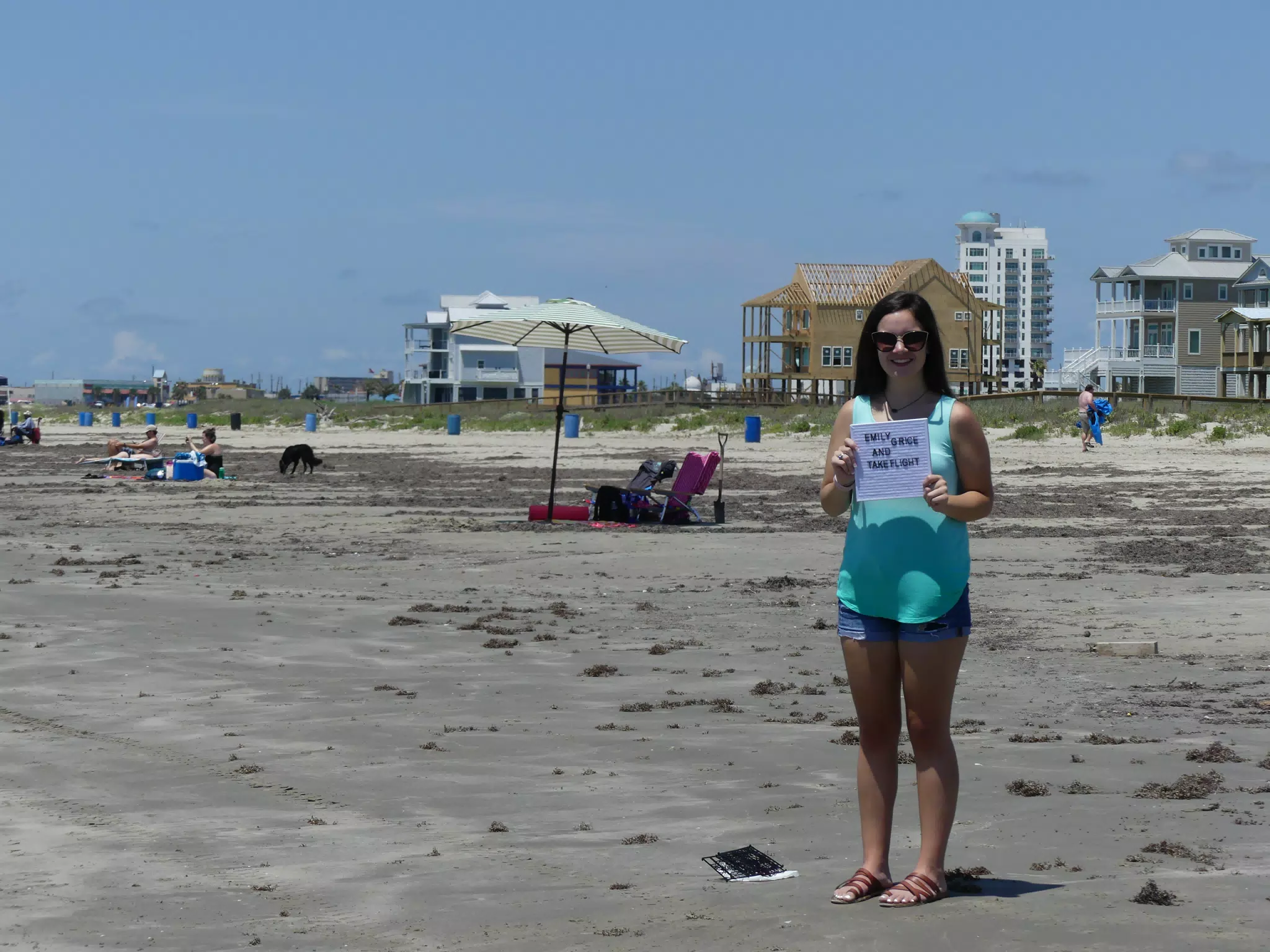 Emily Holding Sign on Galveston Beach