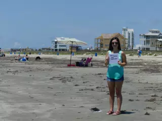 Emily Holding Sign on Galveston Beach