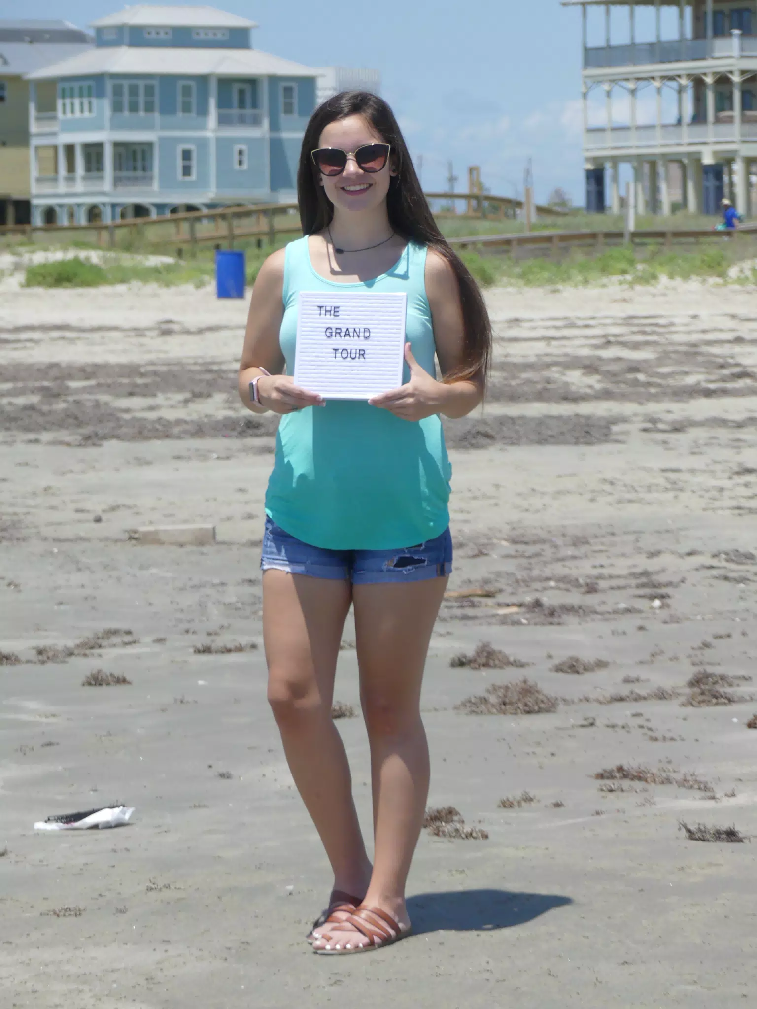 Emily on Beach with Grand Tour Sign
