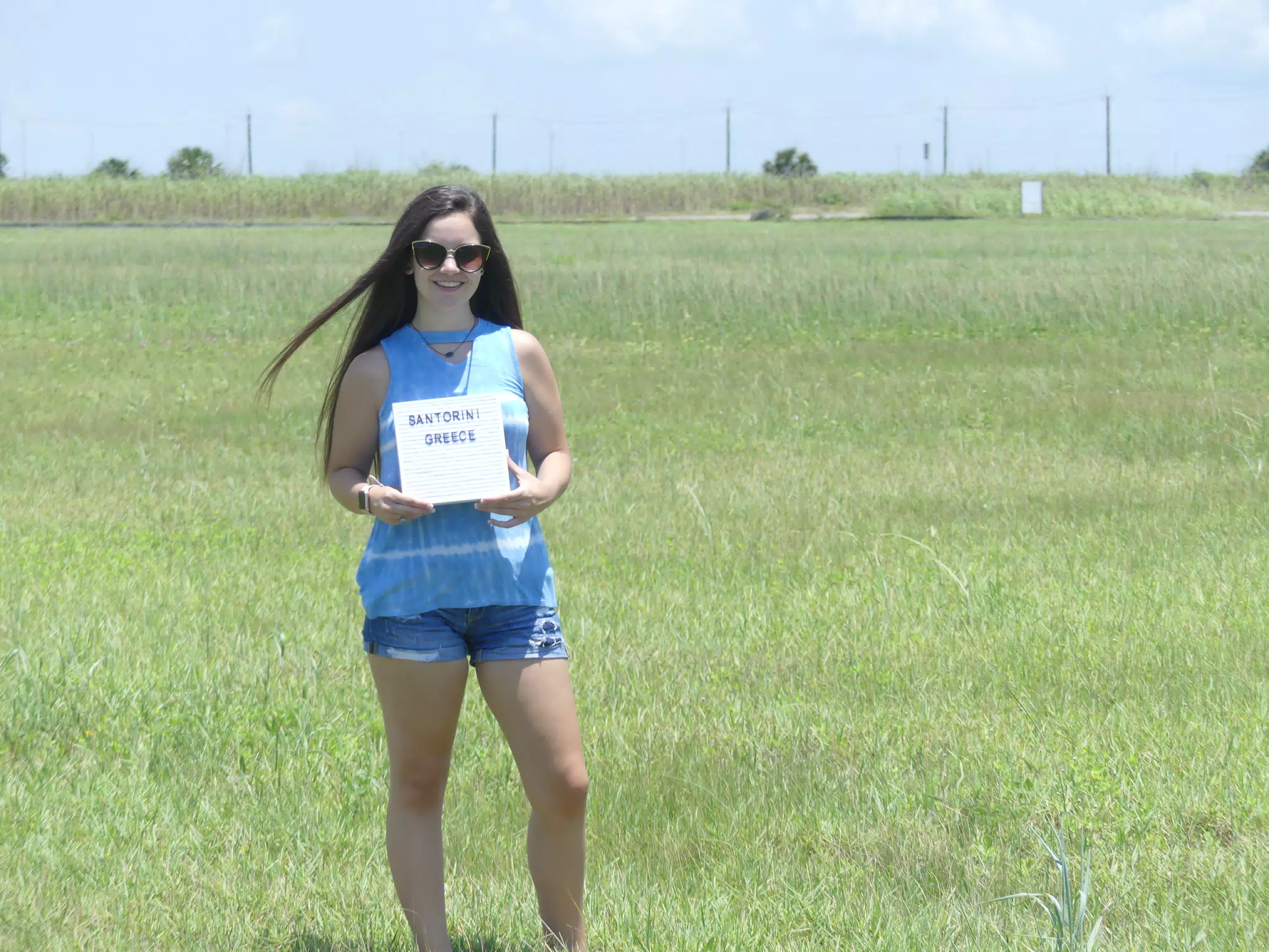 Emily with Santorini Sign on Galveston