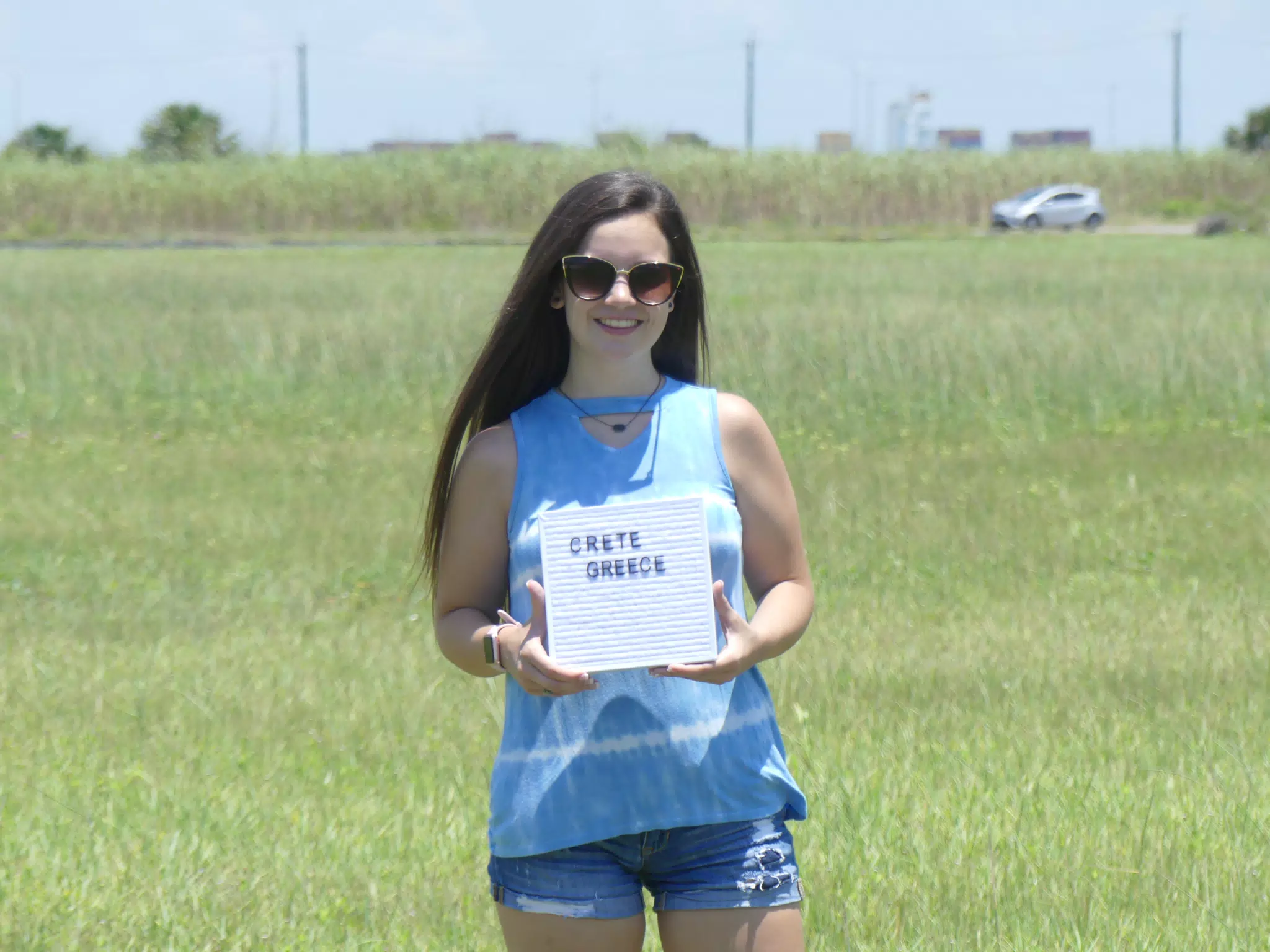 Emily with Crete Sign in Field