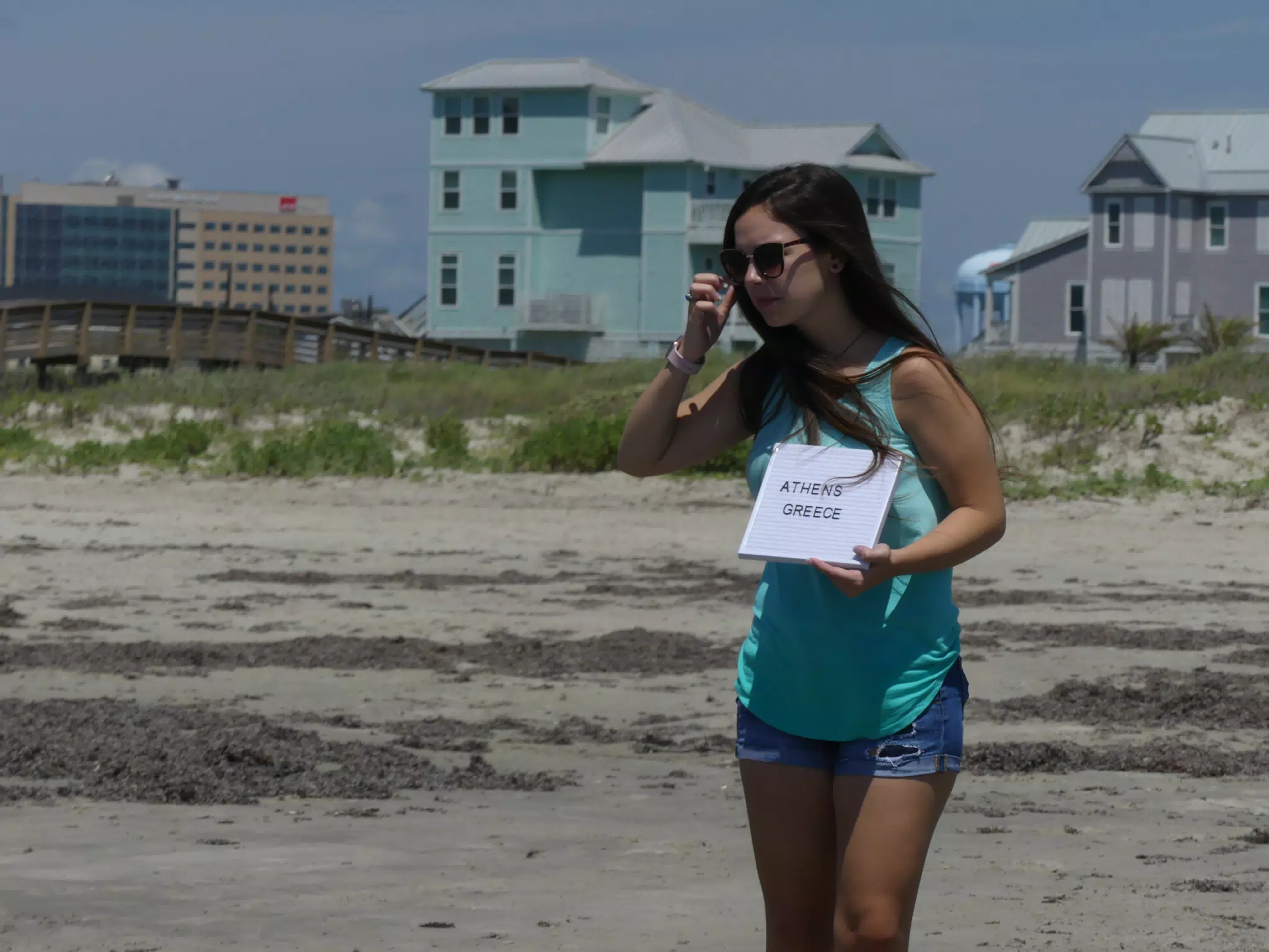 Girl on Beach with Sign