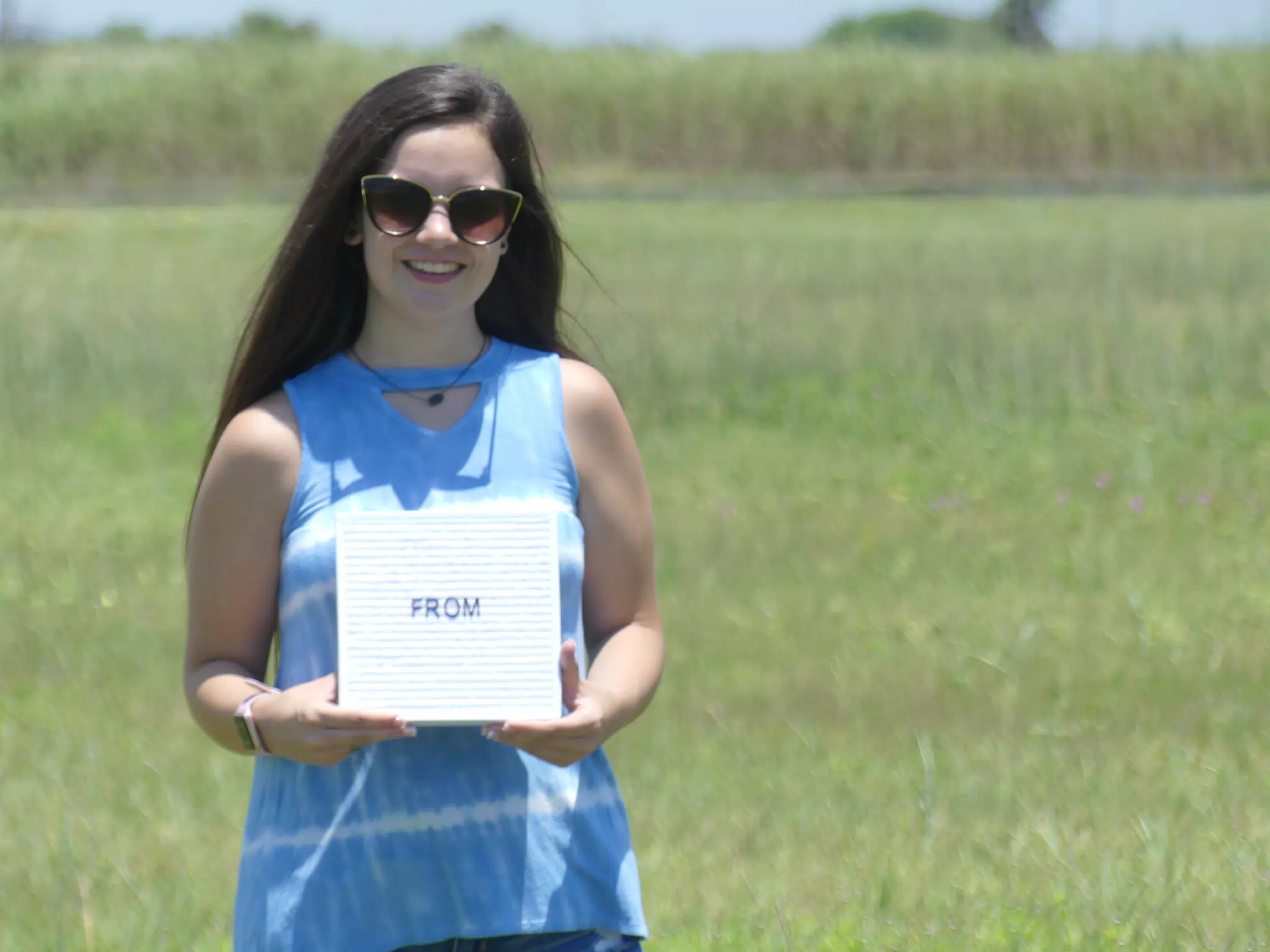 Emily Holding Sign in Field