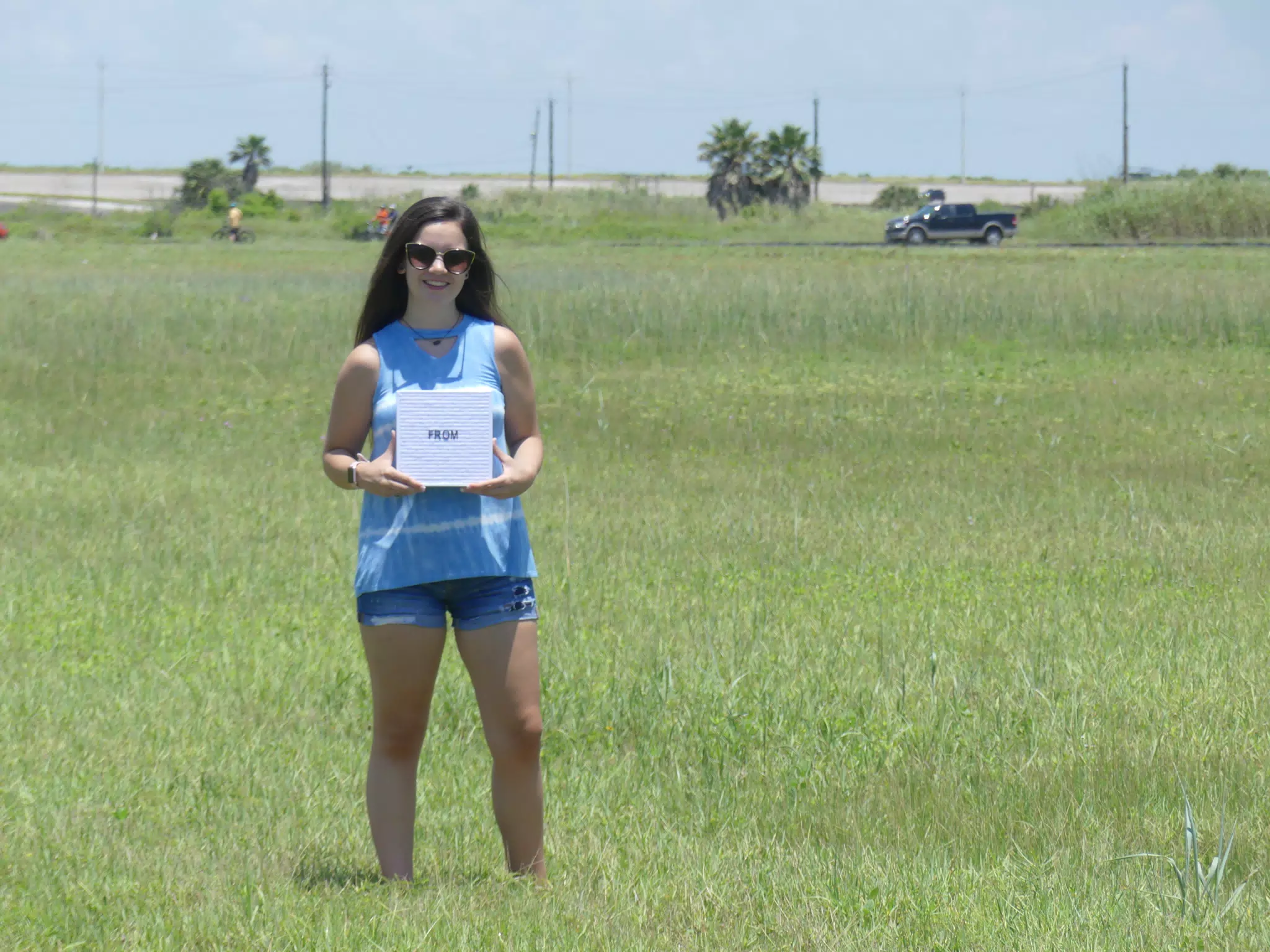Teen in Field with Sign
