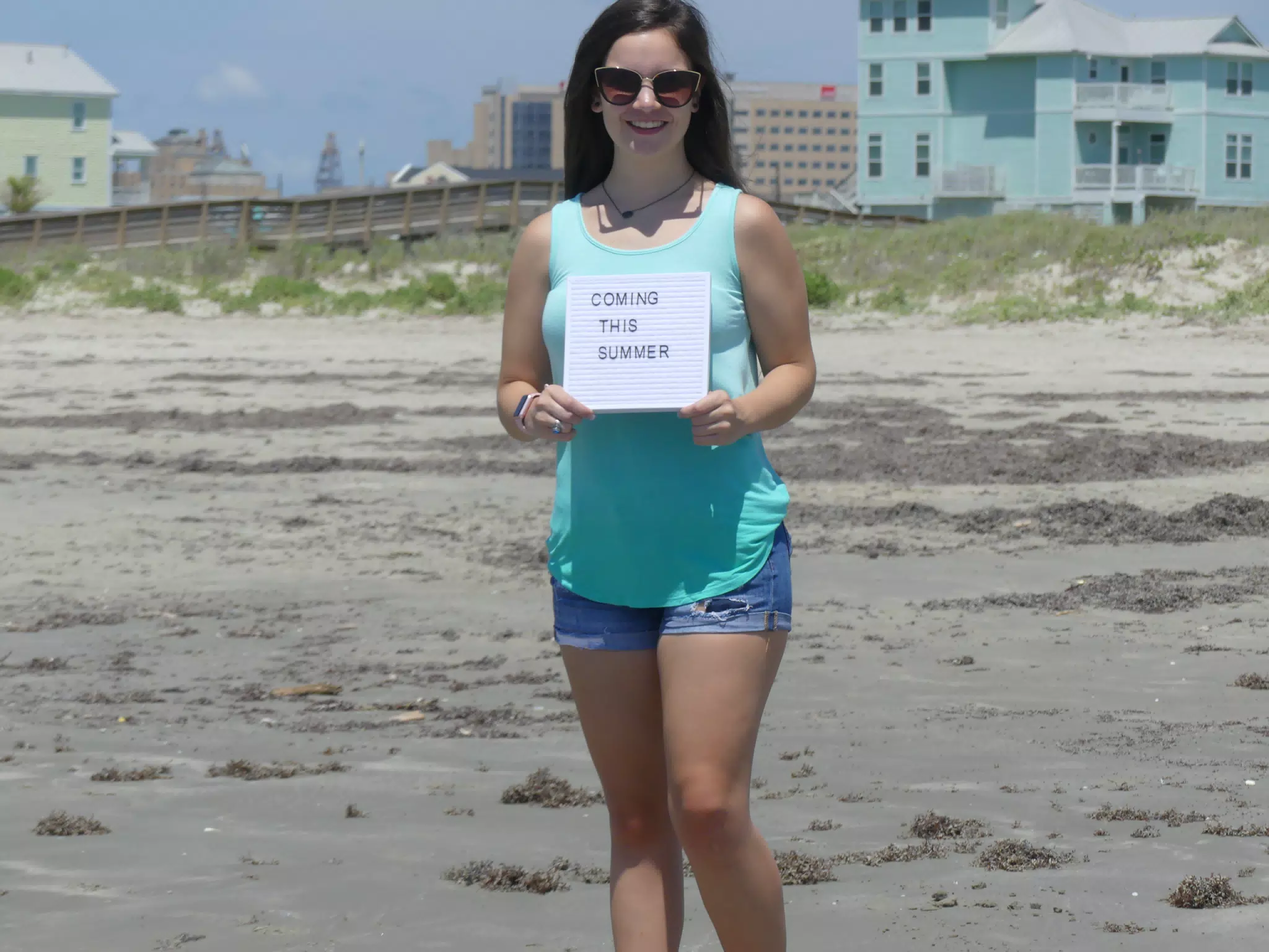 Emily on Galveston Beach with Sign