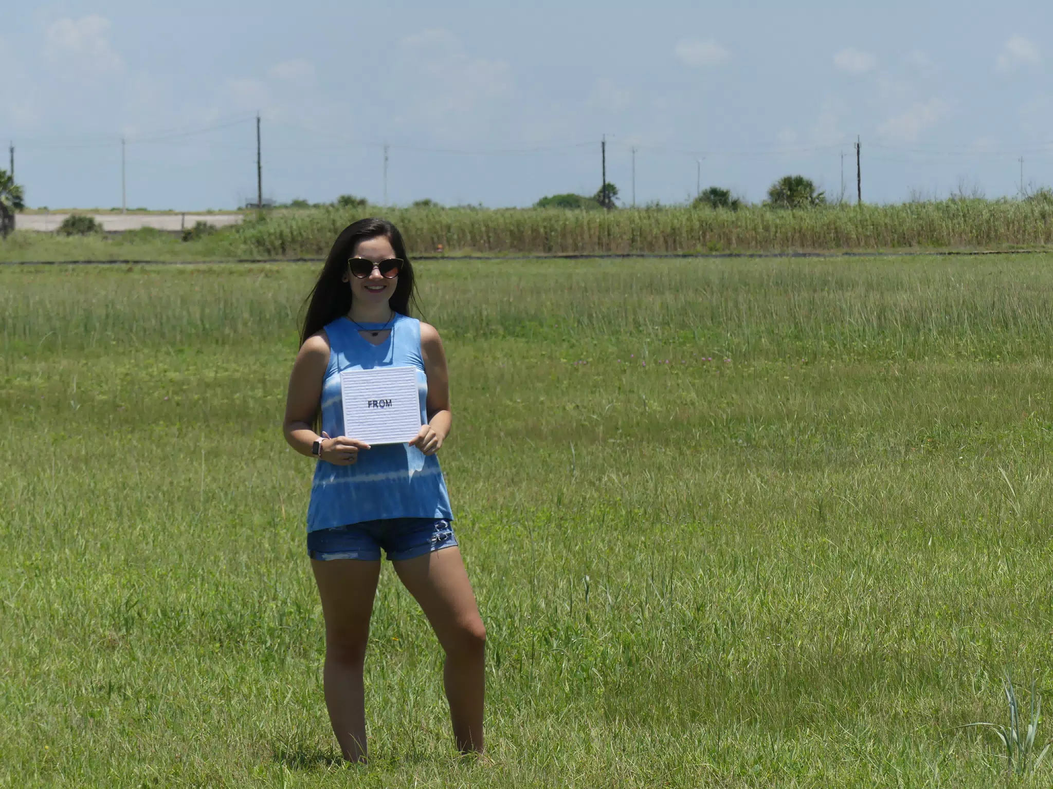 Teen Model in Field with Sign in Jean Shorts