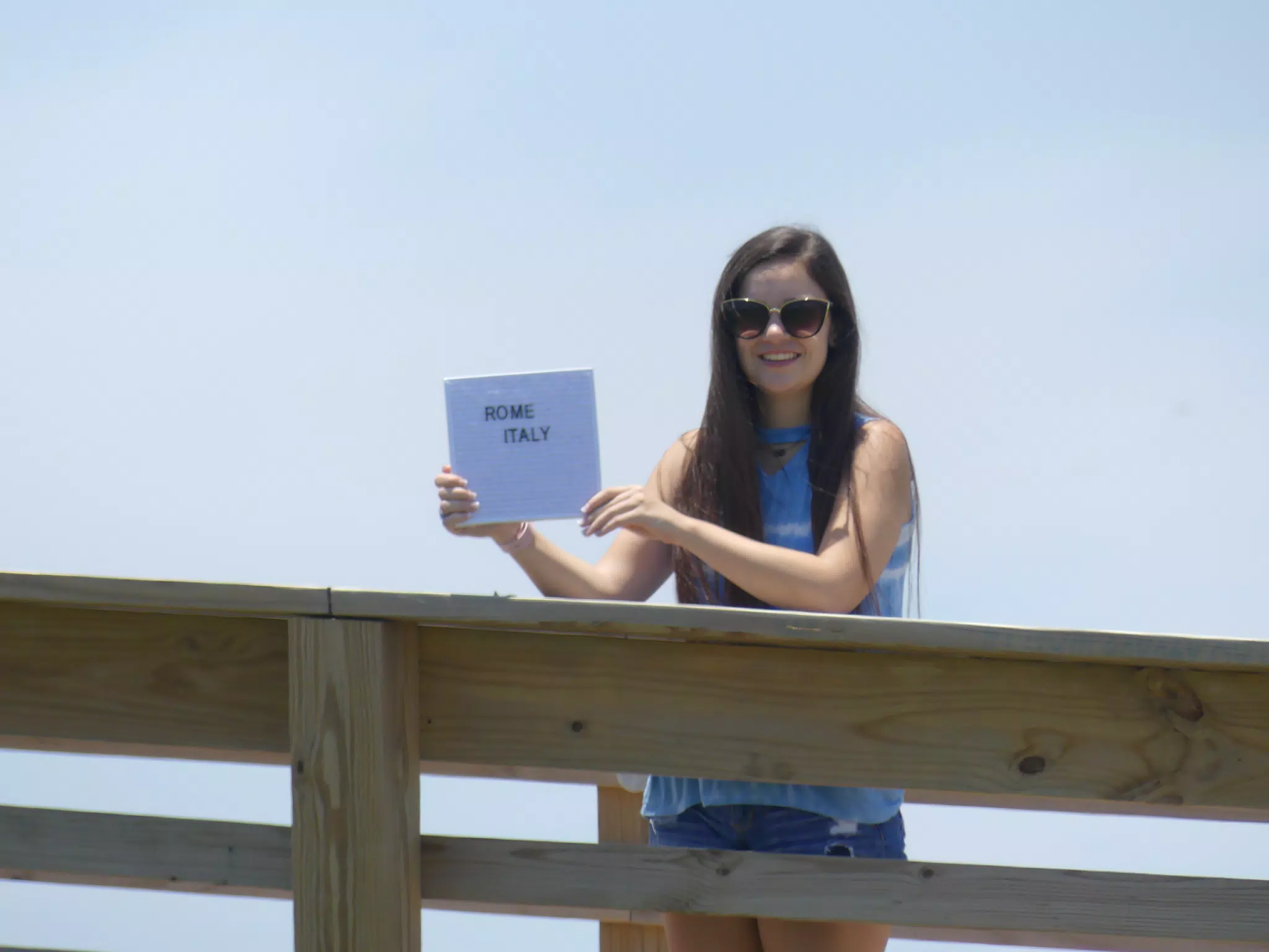 Emily with Rome Sign on Galveston Boardwalk