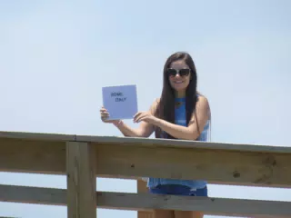 Emily with Rome Sign on Galveston Boardwalk