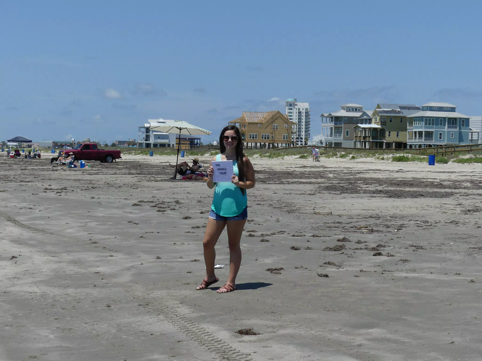 Teen Brunette Posing on Galveton Beach with Sign