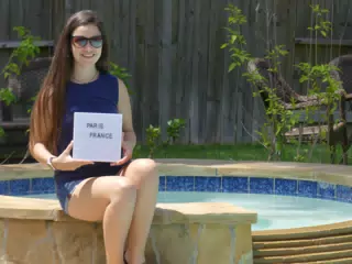 Emily Holding Paris Sign