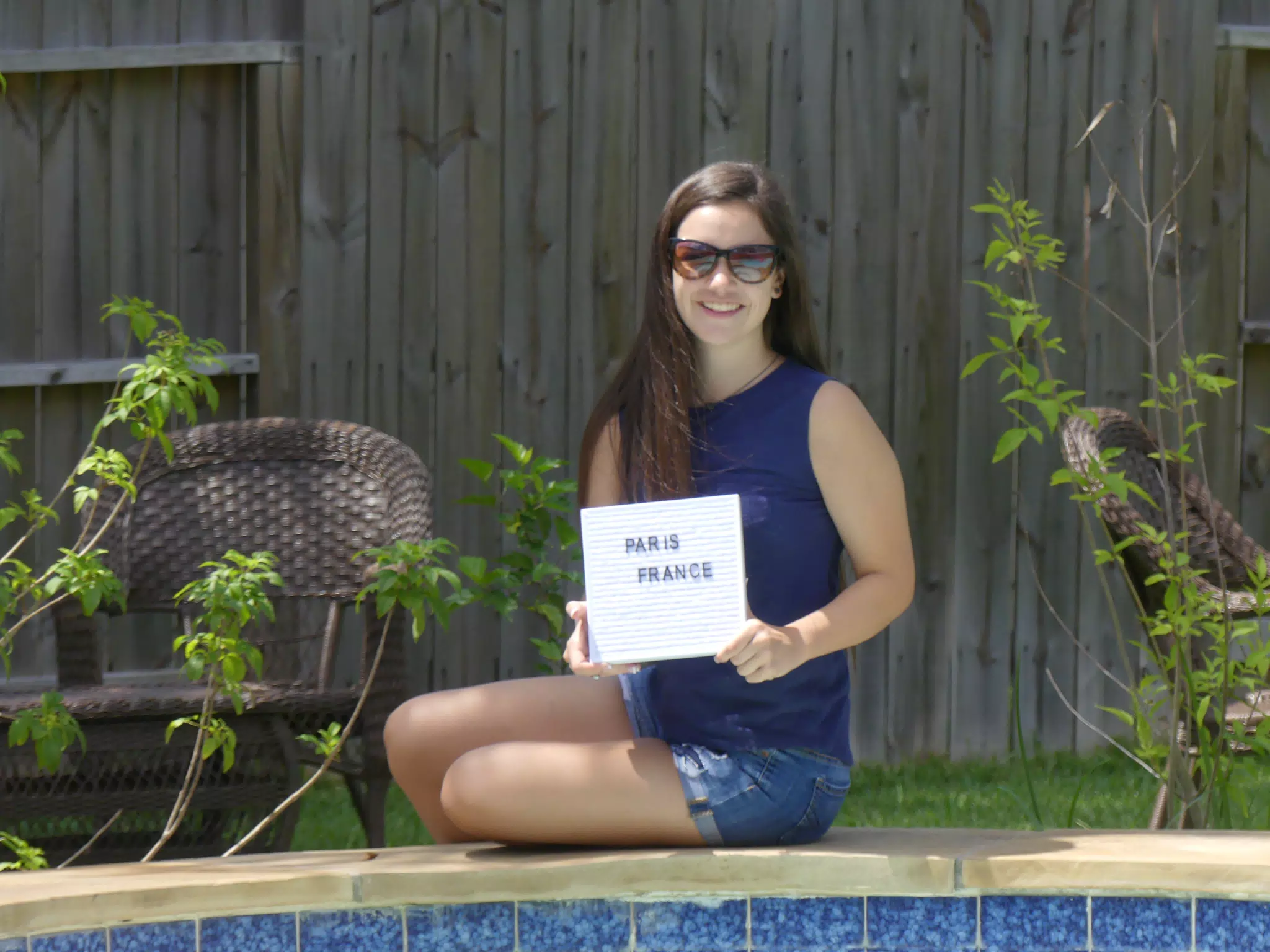 Emily Posing by the Pool in Houstin with Sign in Denim Shorts