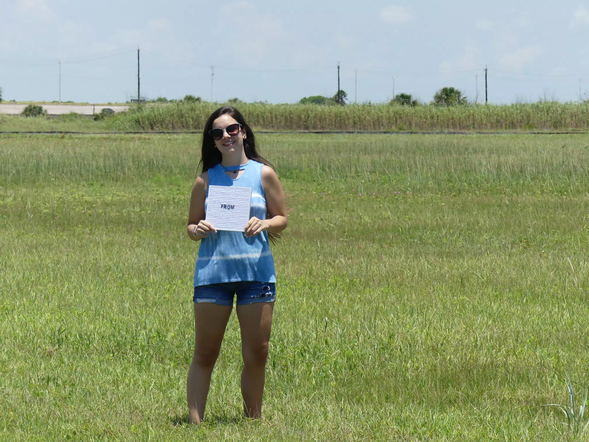 Teen Modeling in Field with From Sign, Galveston