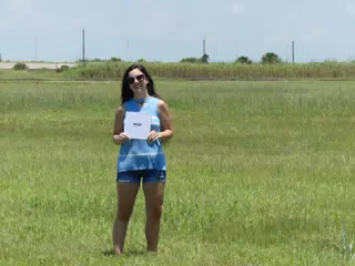 Teen Modeling in Field with From Sign, Galveston