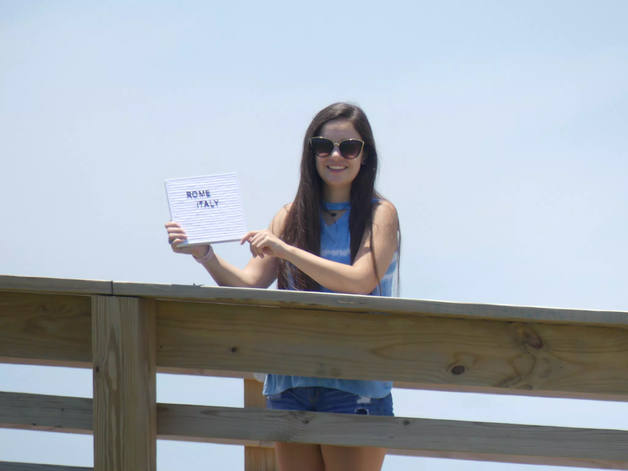 Teen with Sign on Galveston Boardwalk
