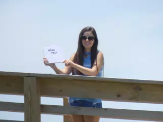 Teen with Sign on Galveston Boardwalk