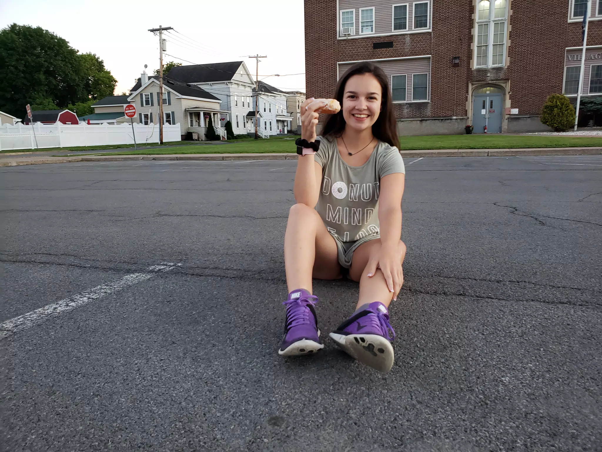 Emily Sitting on Asphalt with Donut