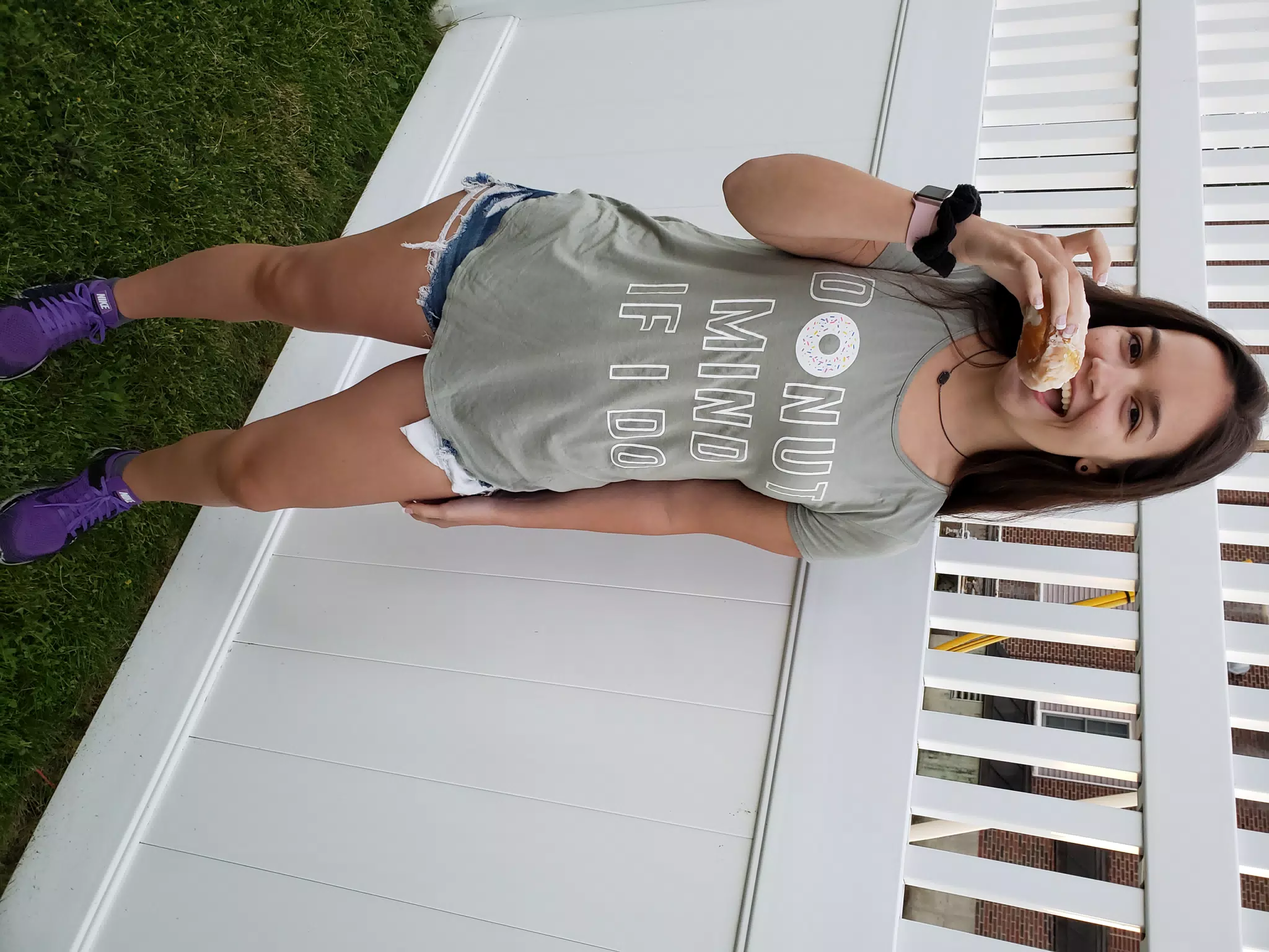 Emily Eating Donut by Fence