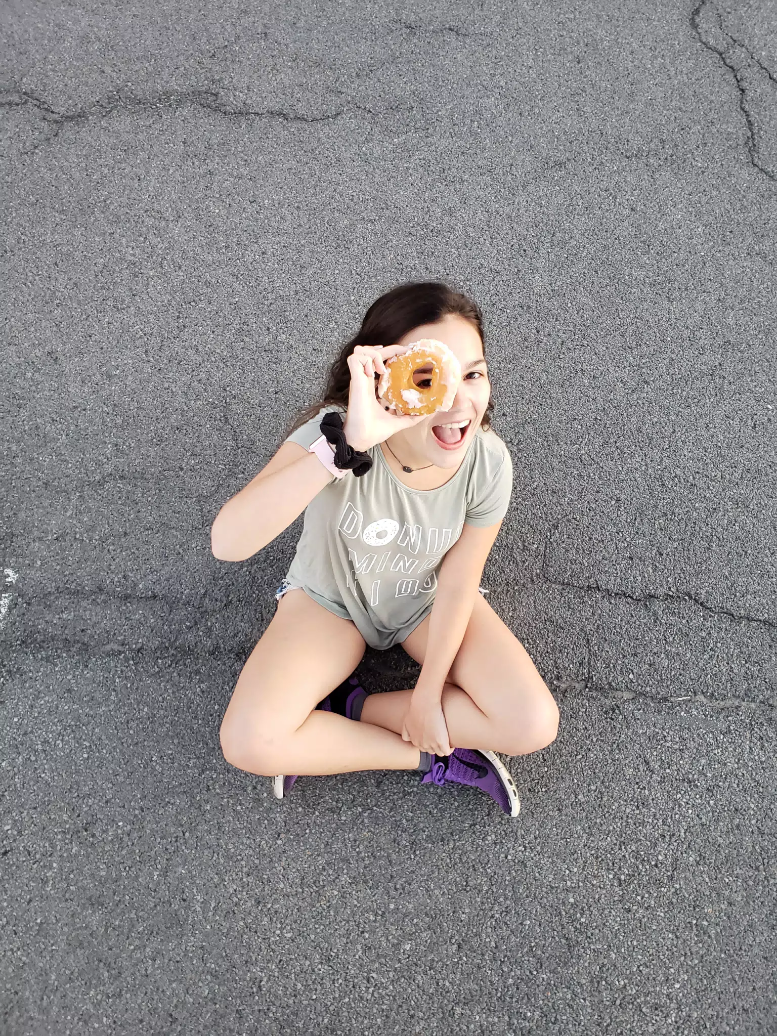 Emily Looking Through a Doughnut