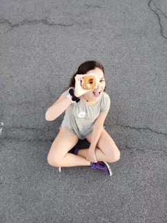 Emily Looking Through a Doughnut