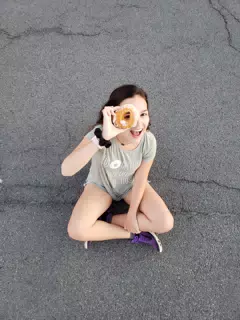 Emily Looking Through a Donut