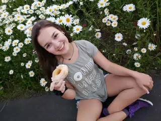 Emily with Doughtnut in Flowers by Driveway