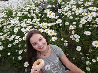 Girl with Doughnut in Daisies