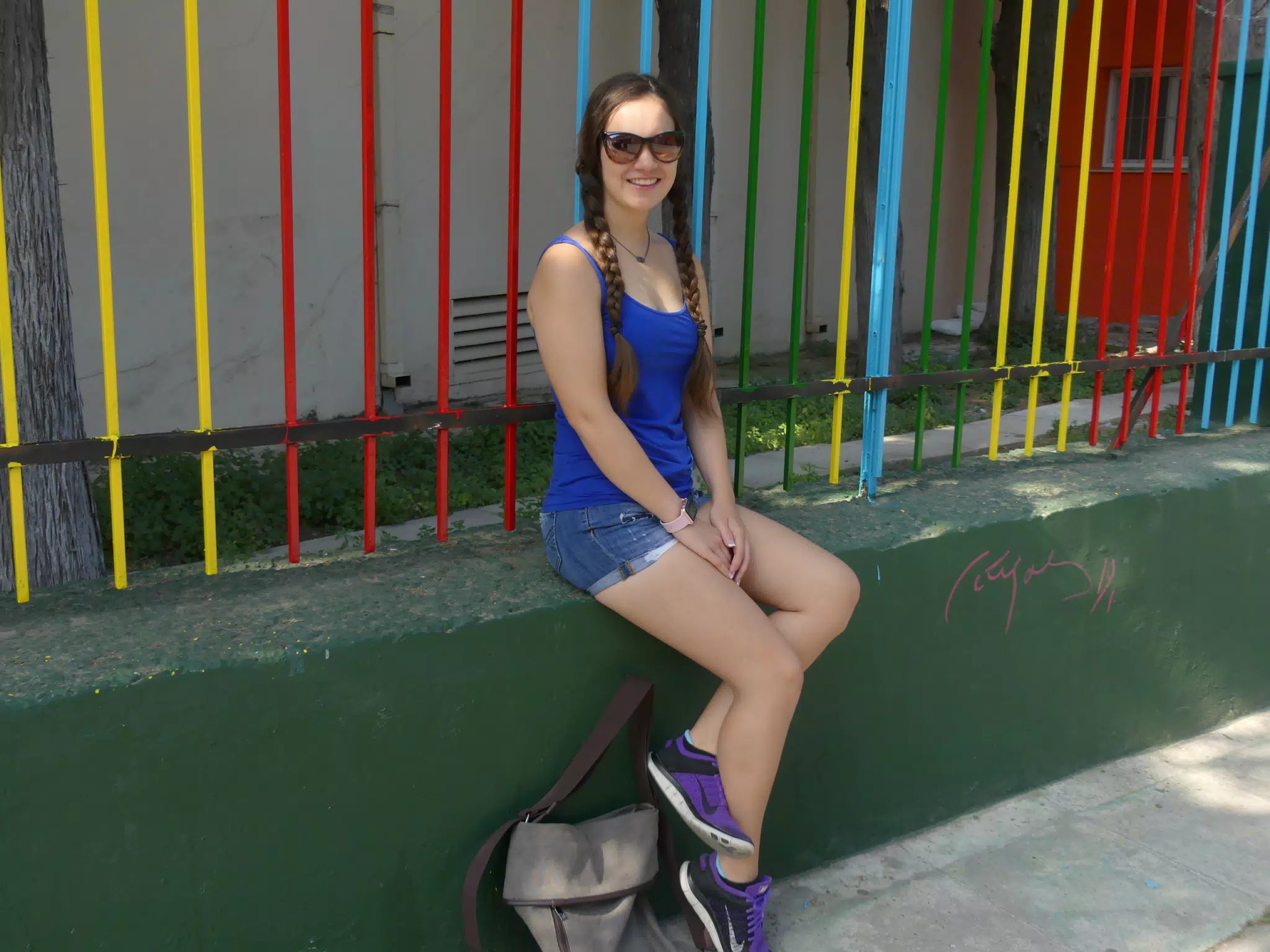 Girl by Colorful Greek Fence