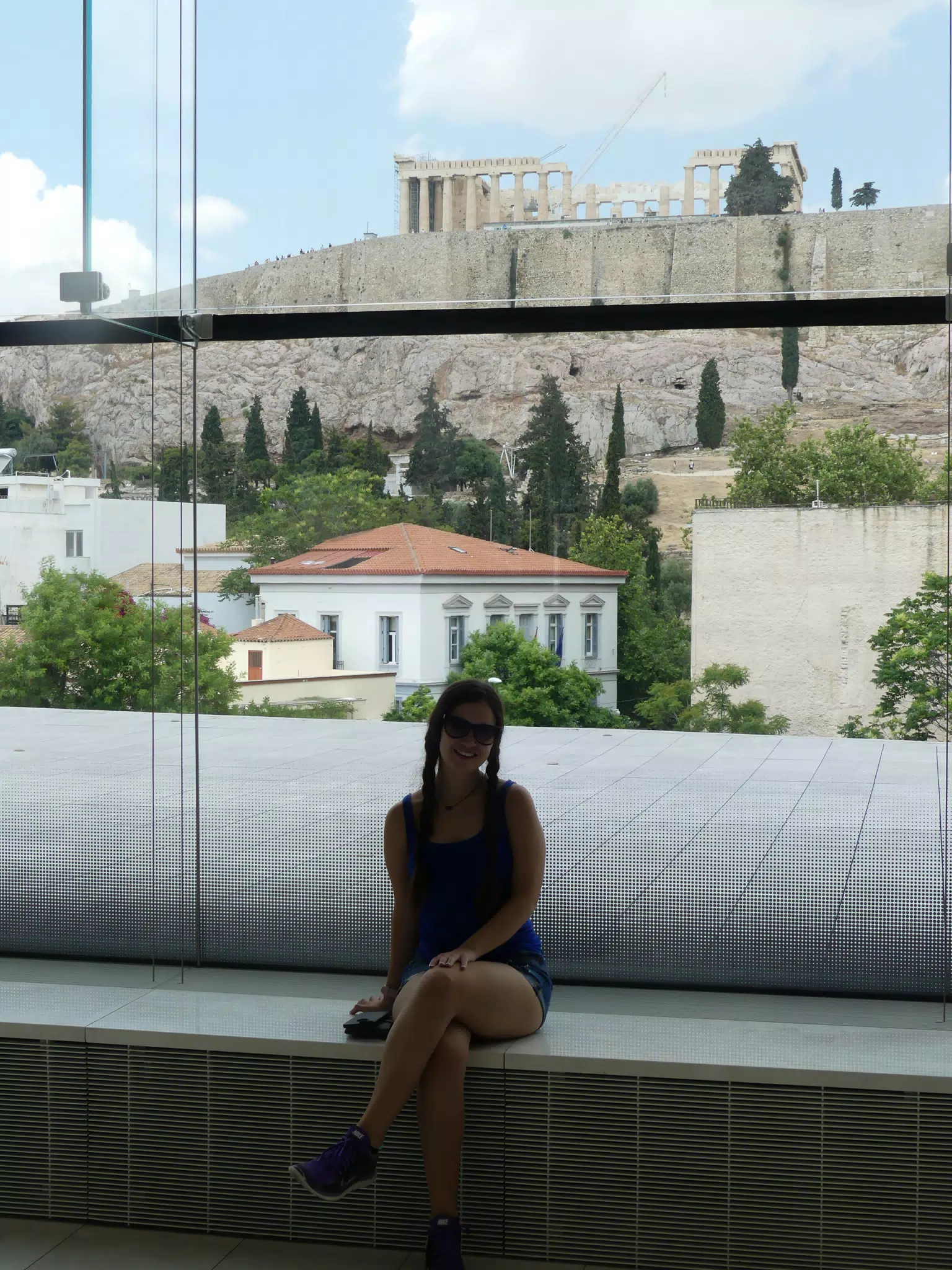 Emily in Window of New Acropolis Museum with Parthenon