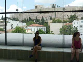Emily by Window in Museum in Front of Acropolis