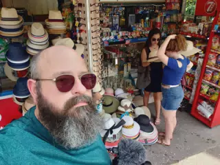 Emily and Madeline Trying on Hats in Athens