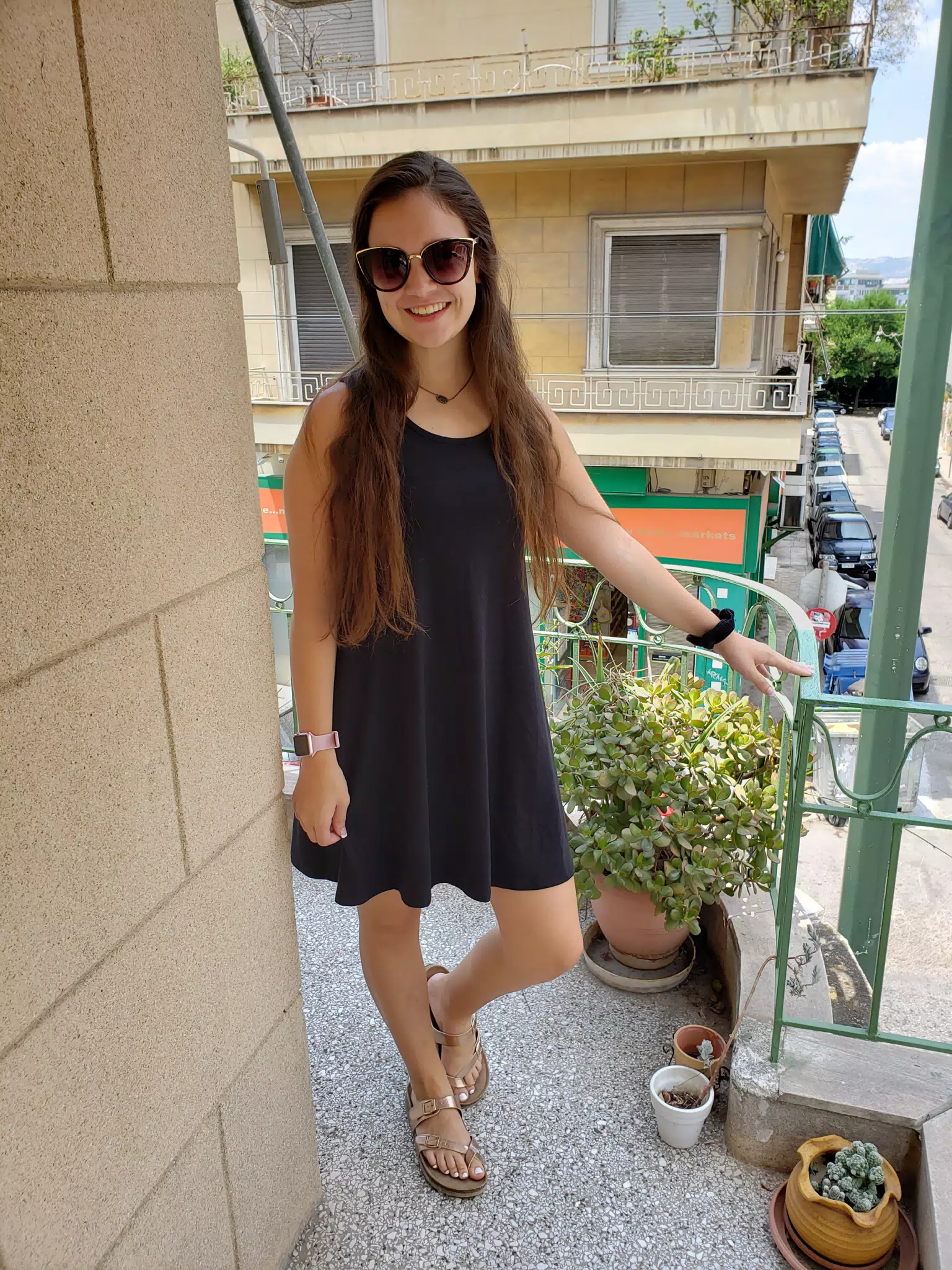Girl in Dress and Sandals on Balcony