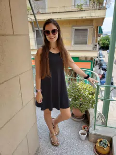 Girl in Dress and Sandals on Balcony