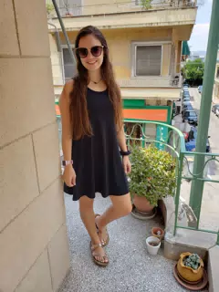Girl in Black Dress on Balcony in Athens