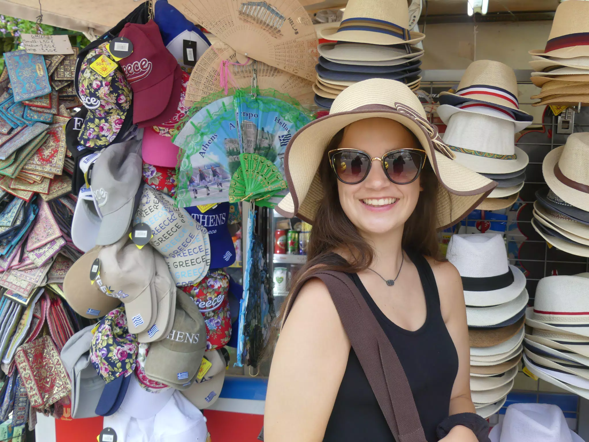 Girl Trying on Hat in Athens