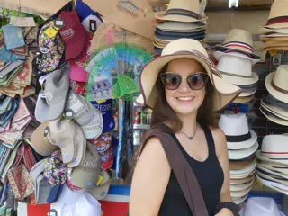 Girl Trying on Hat in Athens