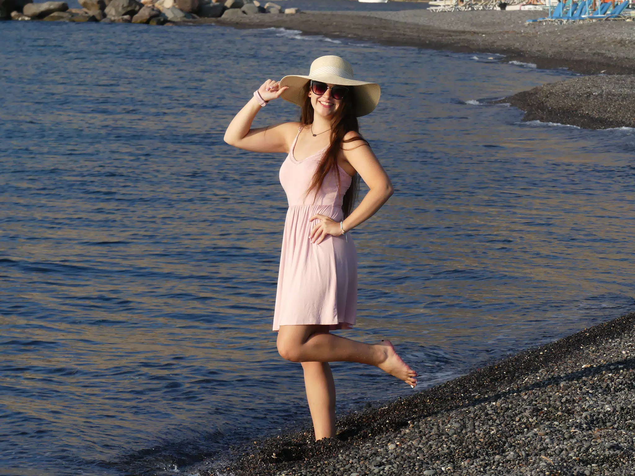 Girl on Santorini Beach in Aegean Sea